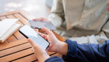 two-people-sharing-contact-info-transferring-files-by-bringing-two-smartphones-close-together_67155-43755